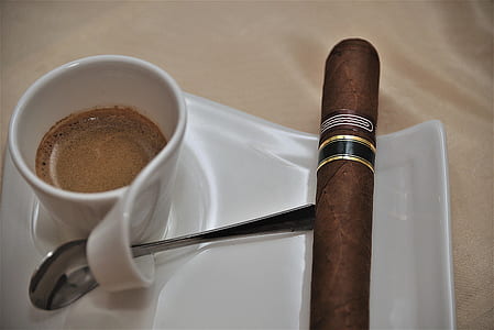 brown tobacco cigarette and ceramic cup with coffee thumbnail