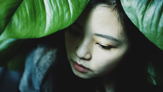 woman in gray shirt under green leaf plant thumbnail