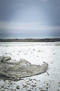 gray net on sand during daytime thumbnail