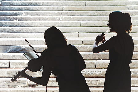 silhouette photo of two person playing instruments thumbnail