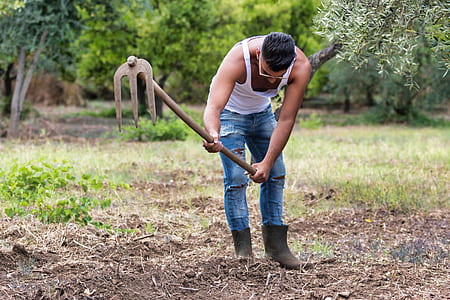 man plowing on ground thumbnail