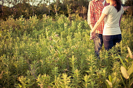 man and woman on green grass field thumbnail