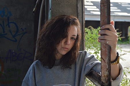 woman standing beside brown steel bar thumbnail