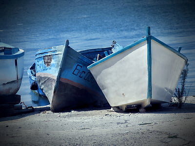 two white and blue boats near seashore thumbnail