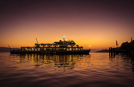 lighted boat on body of water thumbnail