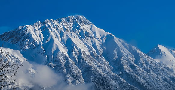 snow covered mountain under blue sky thumbnail