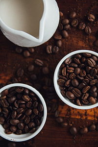 two cups of coffee beans beside pitcher thumbnail