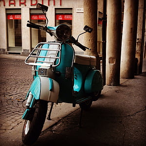 teal and white motor scooter parking near building at daytime thumbnail