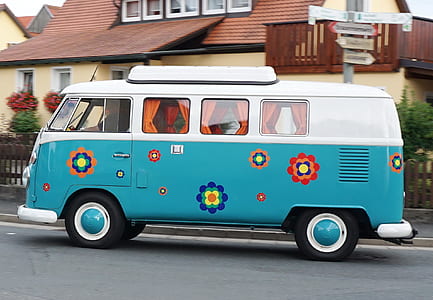 white and blue Volkswagen van on road near residential building thumbnail