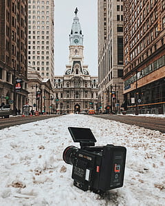 black professional video camera on snow ground surface thumbnail