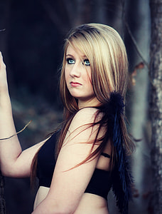 photo of woman with blonde hair wearing black brassier in forest thumbnail