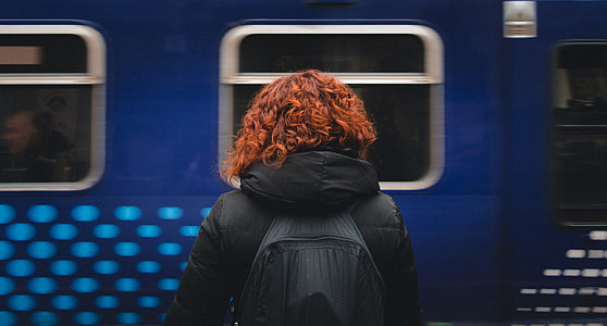 woman standing beside vehicle during daytime thumbnail
