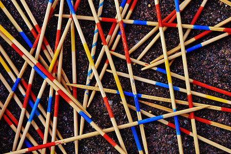 assorted-color sticks overlap on black wall thumbnail