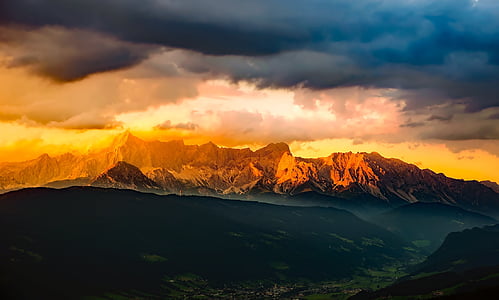 landscape photography of mountain under cloudy sky thumbnail