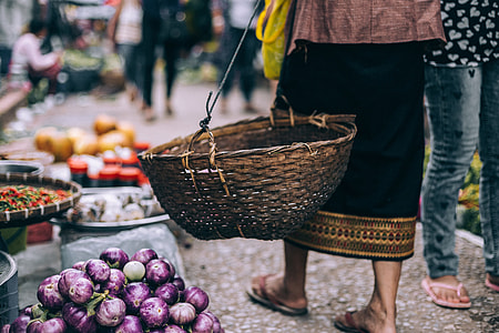 woman holding wicker brown basket thumbnail