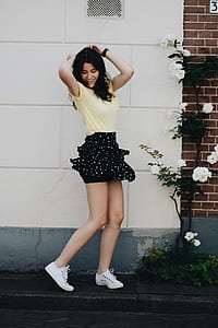 woman wearing yellow shirt and black skirt thumbnail