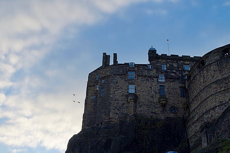 low angle photography of brown concrete castle on top hill thumbnail