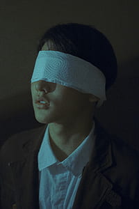 closeup photo of woman with blindfold on her eyes thumbnail