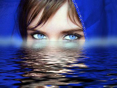 woman with blue eye lens and head scarf on body of water thumbnail