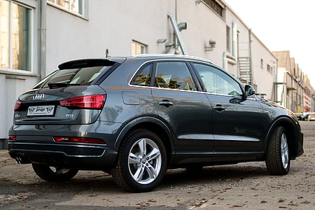 black Audi QX-Series on road during daytime thumbnail