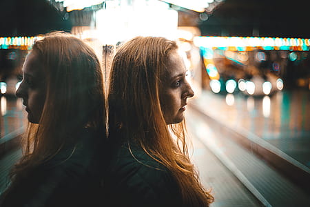 woman leaning on the wall reflecting her image thumbnail