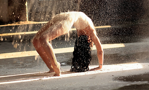 woman bending body on gray concrete floor thumbnail