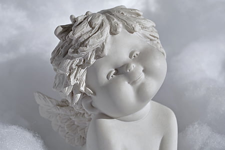 shallow focus photography of angel figurine thumbnail