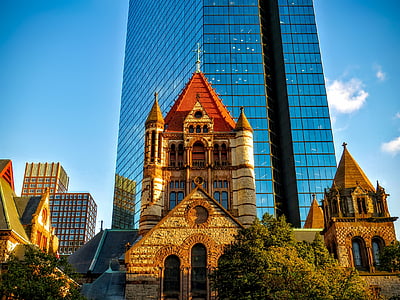 blue glass building near church thumbnail