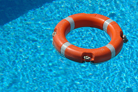 orange survival ring floating on swimming pool thumbnail