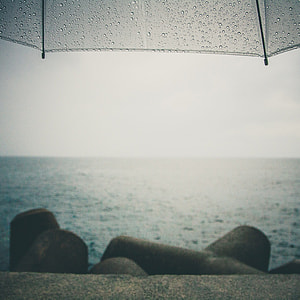 umbrella with raindrops on the shore thumbnail