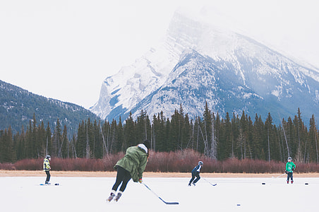 People playing Hockey on frozen lake in Banff National Park, Alberta, Canada thumbnail