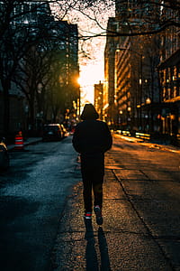 Photography of Person Walking On Road thumbnail