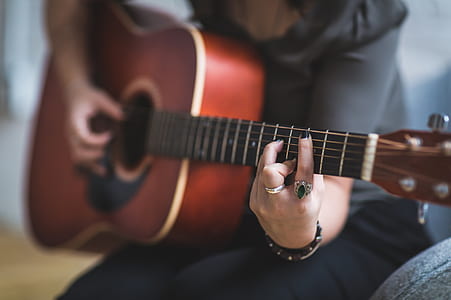 person plying acoustic guitar thumbnail