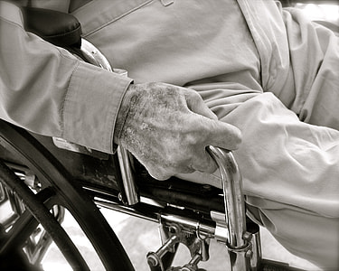 grayscale photo of person seating on wheelchair thumbnail