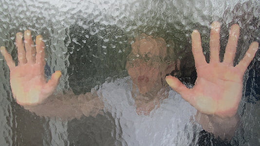 photo of person's hand on glass window thumbnail