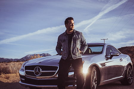 man standing in front of Mercedes-Benz coupe thumbnail
