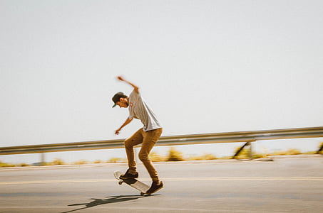 man riding skateboard on road during daytime thumbnail