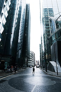 woman standing in between buildings thumbnail