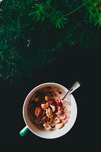 assorted peanuts on bowl near green grass thumbnail