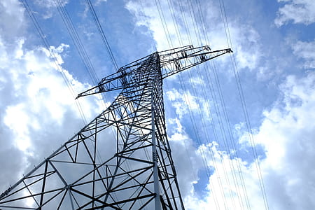 black and gray electric post under blue skies thumbnail