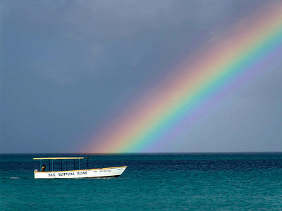 Rainbow over the ocean with a boat in Jamaica thumbnail