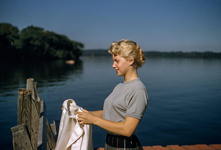 woman holding white cloth on dock thumbnail
