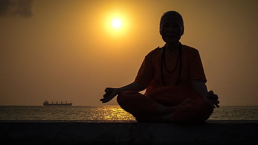 person doing yoga near body of water thumbnail