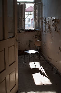 white and gray armless chair in room thumbnail