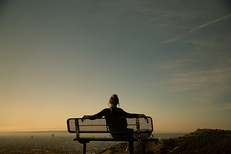 silhouette of woman on gray bench thumbnail