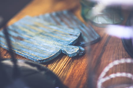 selective focus photography of teal decor on brown surface thumbnail
