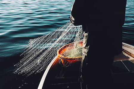 fisherman standing on boat thumbnail