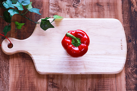 red bell pepper on wooden chopping board thumbnail