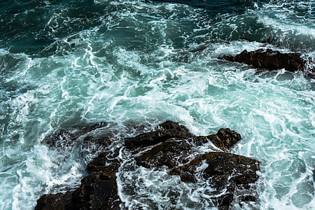 black rock on body of water thumbnail