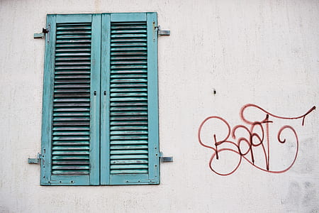 red wall print near blue louver window door thumbnail